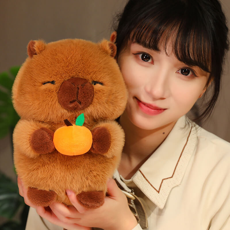 25CM Capybara Plush Doll Holding an Orange